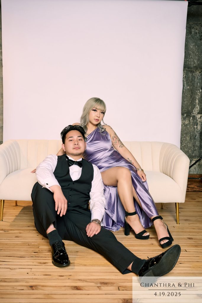 Wedding guests at the Portrait Lounge, she on the sofa in lavender satin, he on the floor