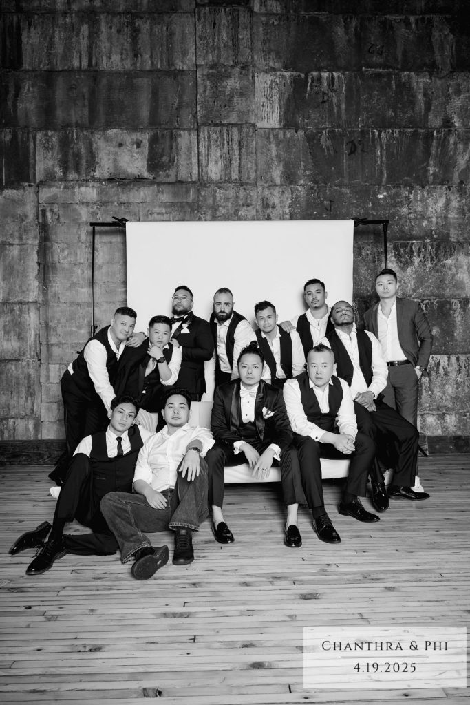 The groom and his groomsmen around the Portrait Lounge sofa, black and white