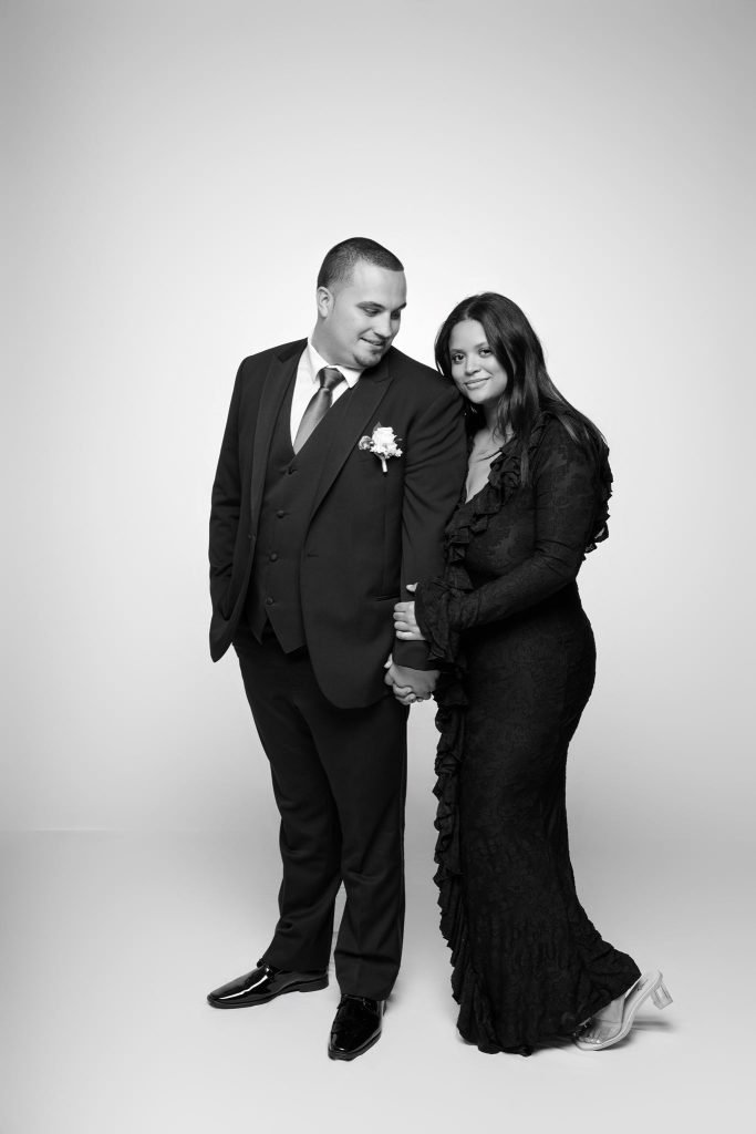 Wedding guest portrait on a white seamless backdrop, black and white